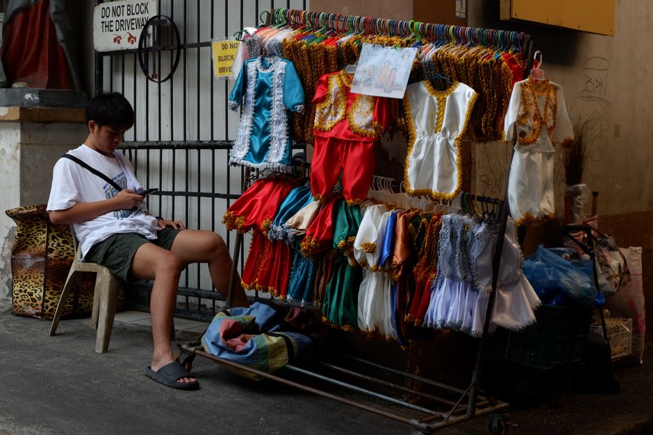 A person using a smartphone at a street market