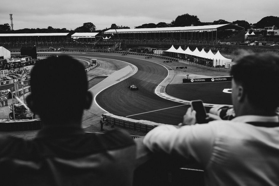 A grandstand crowd watching a motor race