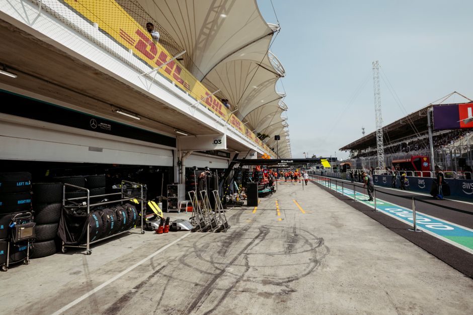 Cars and crews in a race circuit pit lane
